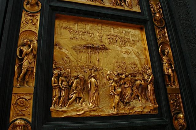 A close up of the bronze panel depicting the story of Joshua, with the arc of the covenant and the city of Jericho. Joshua lived a righteous life in the name of God and because of this, he was able to destroy all of his enemies and reclaim the Promised Land. 